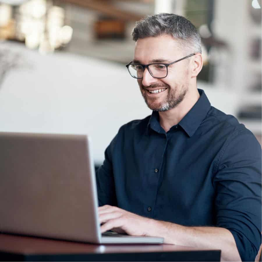 Photo of a man using his computer