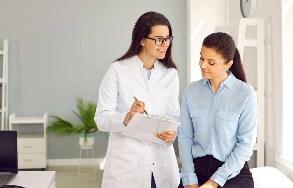 Medicine. The doctor writes a prescription or makes notes on the patient's card during the medical examination.